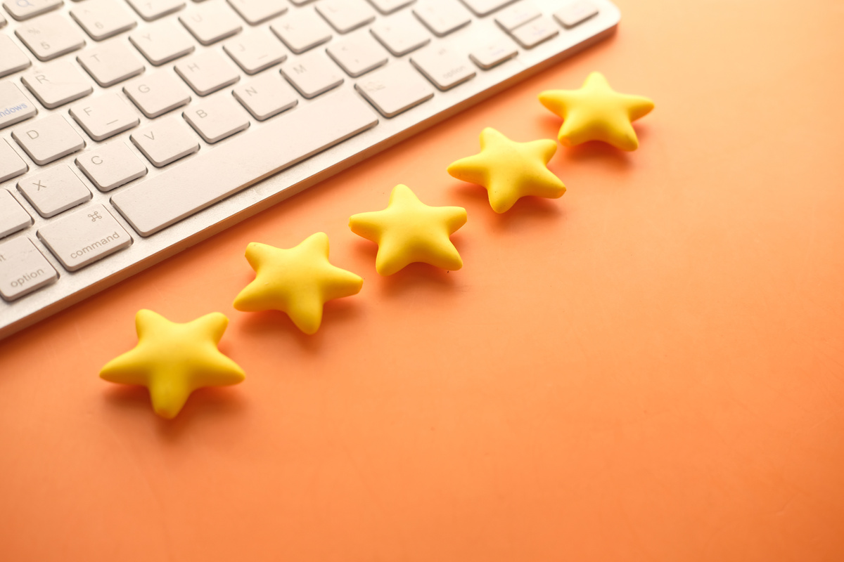 Customer Review Concept. Rating Golden Stars on Orange Background